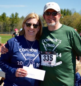Mark Whitney presents a check to Tara Ball at the annual 5K Road Race