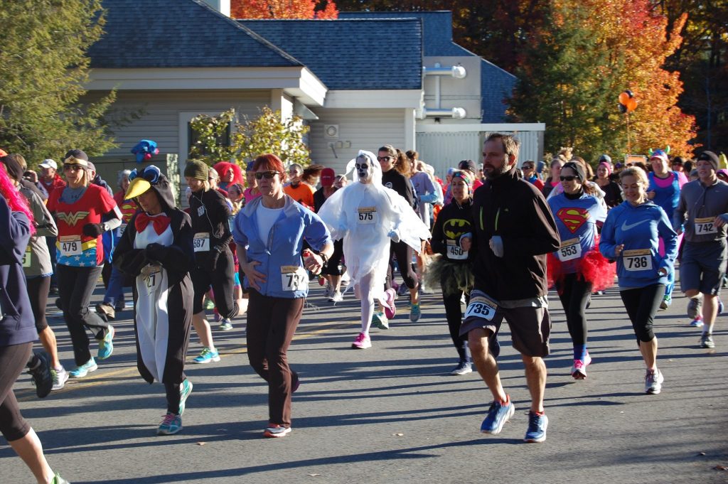 People in costume running the Exeter Hospital Trick or Treat Trot 5k